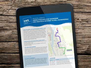 Ein Tablet-Computer auf einem Holztisch, darauf ist eine Pressemeldung zu sehen.